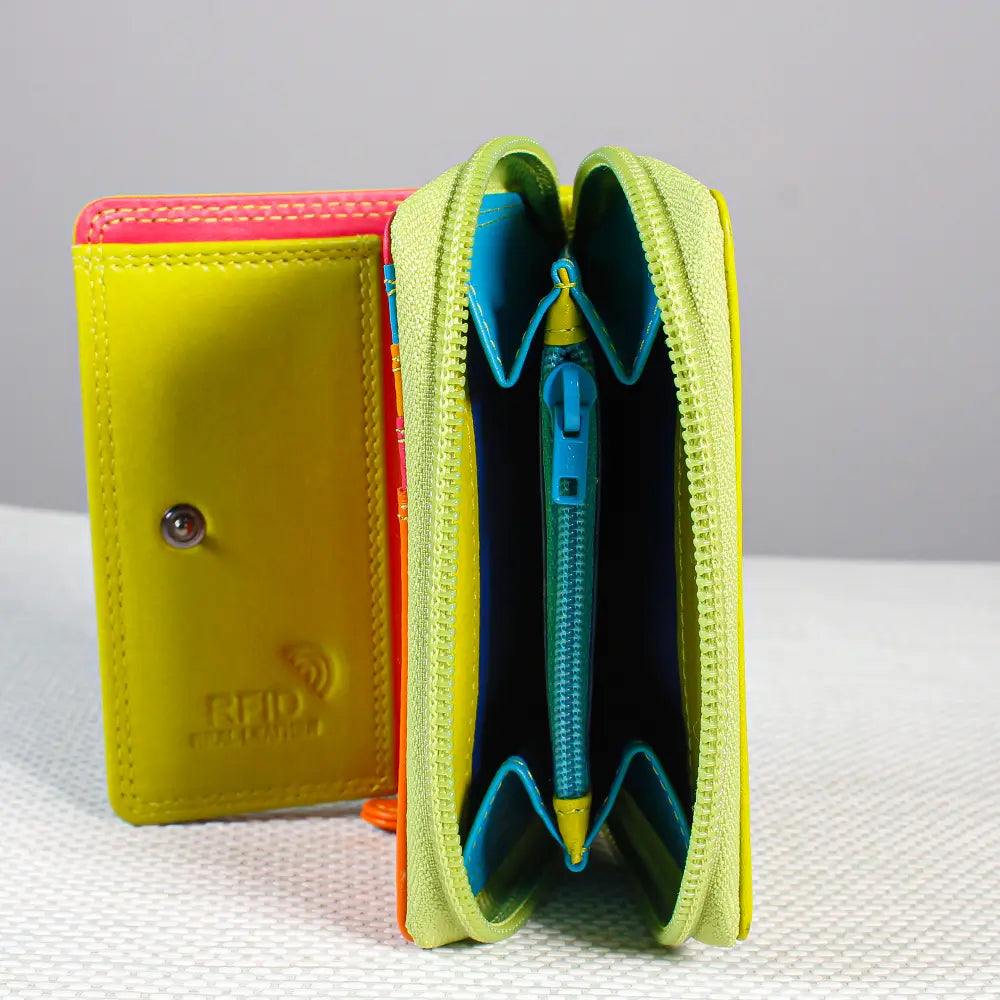 Green wallet with a pen inside on a textured surface