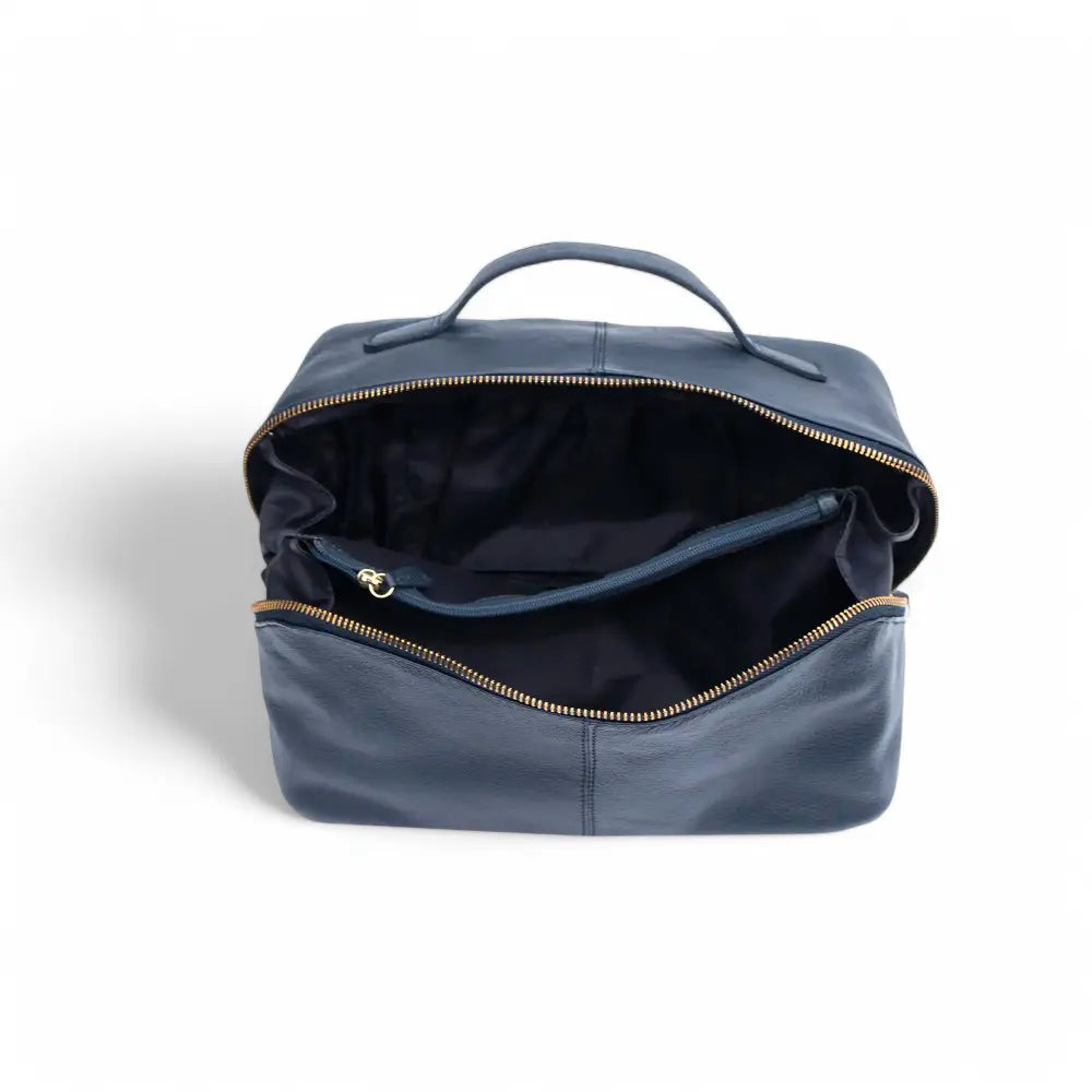 Large Leather Makeup Washbag in navy blue, showcasing its soft leather exterior, structured rectangular shape, and sturdy top handle.