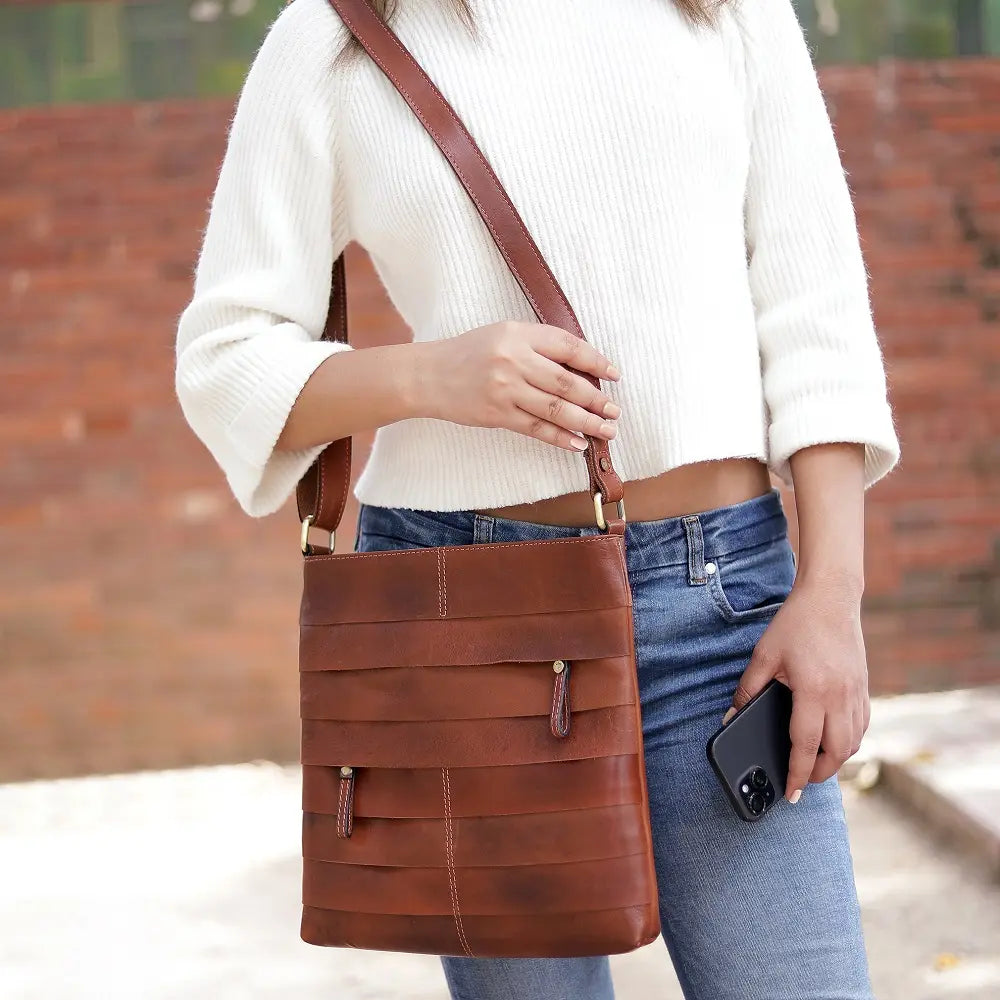 Boho Layered Leather Bag - Ridgeback displayed on a stylish cane chair, emphasising its rich distressed leather and handcrafted design, perfect as a timeless accessory.