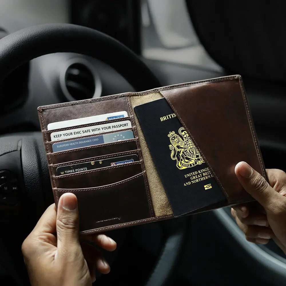 Two people holding leather passport wallets 