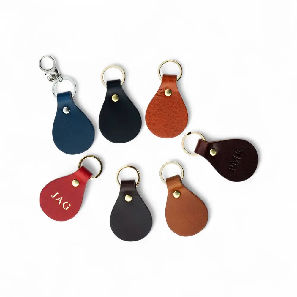 Set of leather keychains in various colors on a white background
