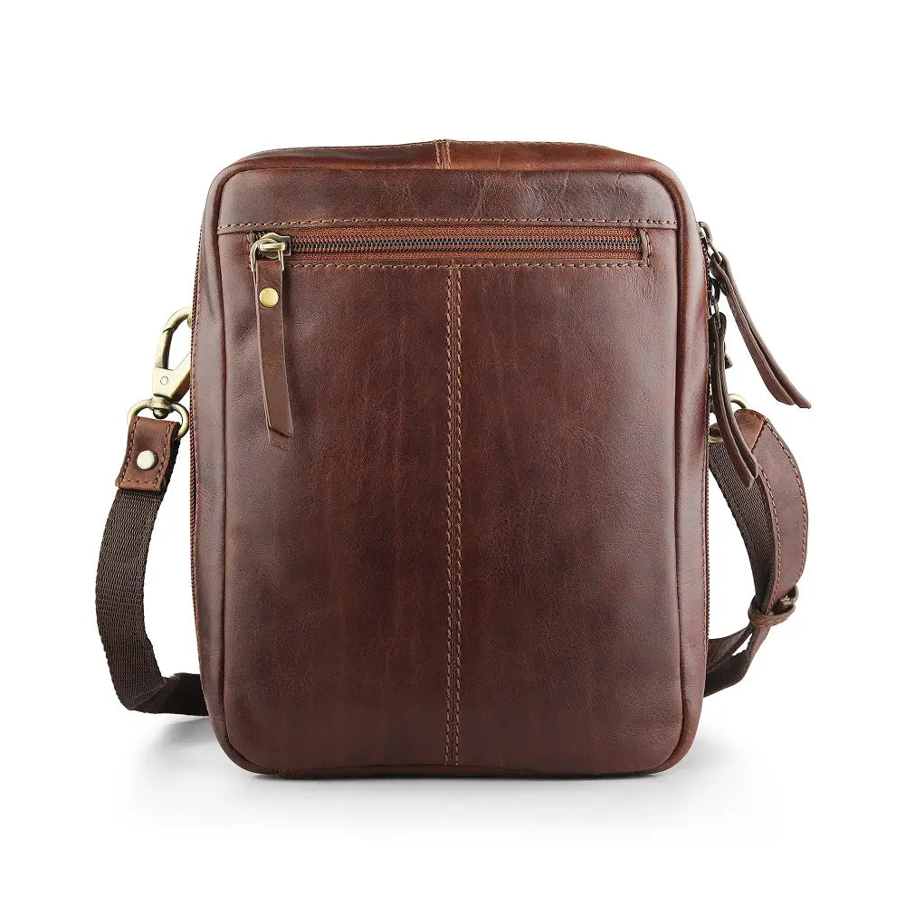 Brown leather crossbody messenger bag styled on a wooden surface, highlighting classic design and premium finish