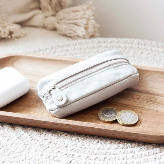 Life style view of Ligth Grey Small Leather Zipper Keyring Pouch on grey background