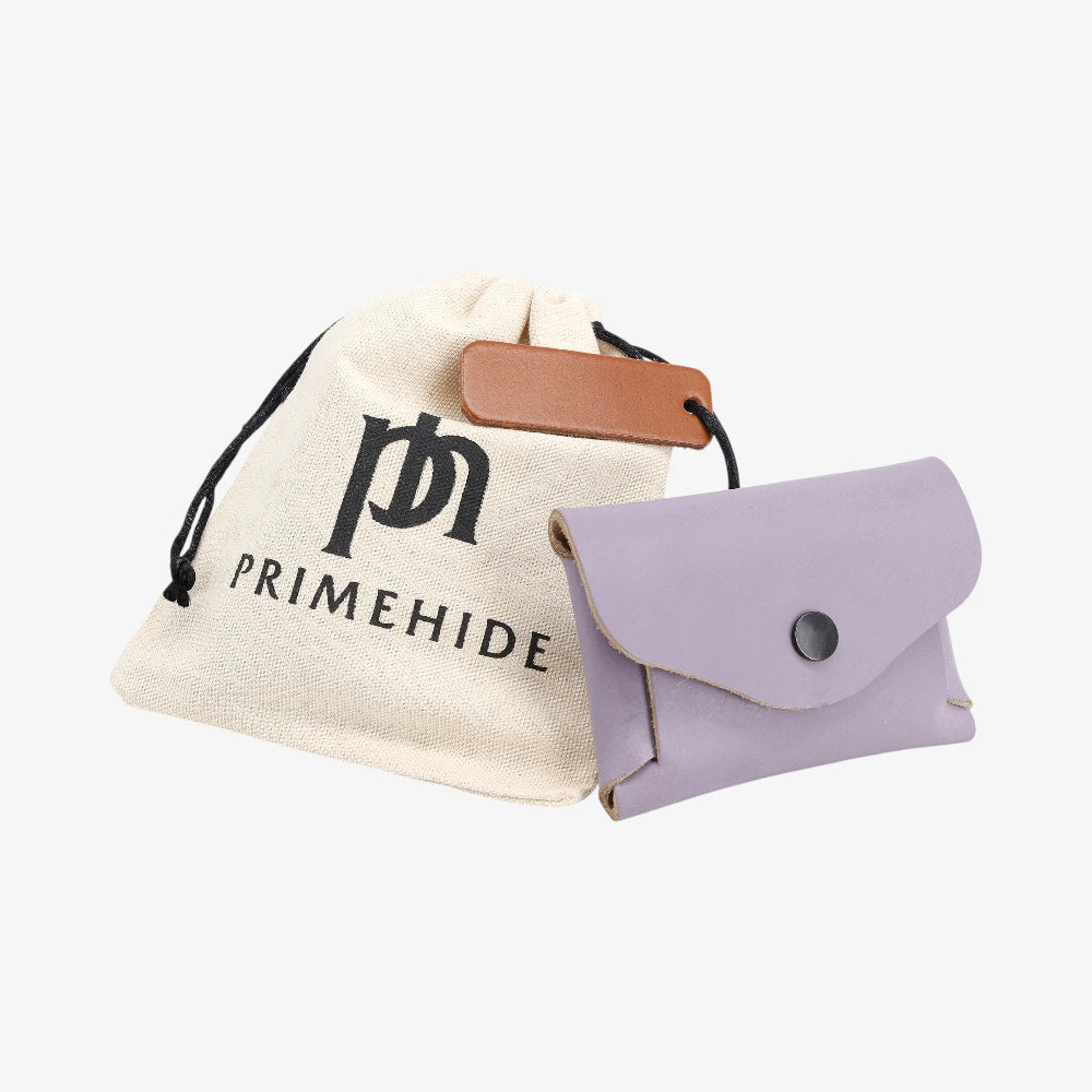Lilac leather coin purse with flap closed displayed beside Primehide dust bag