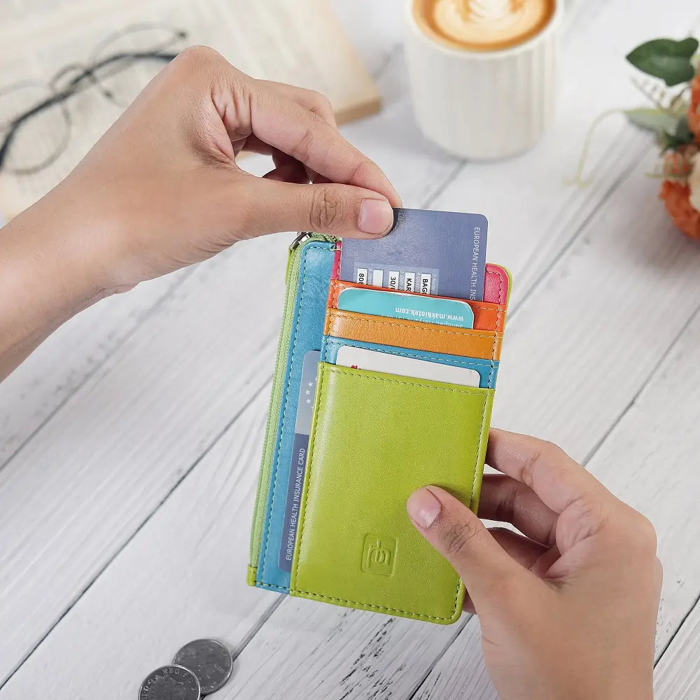 Lime Card Holder Purse with cards held by hands on a wooden surface