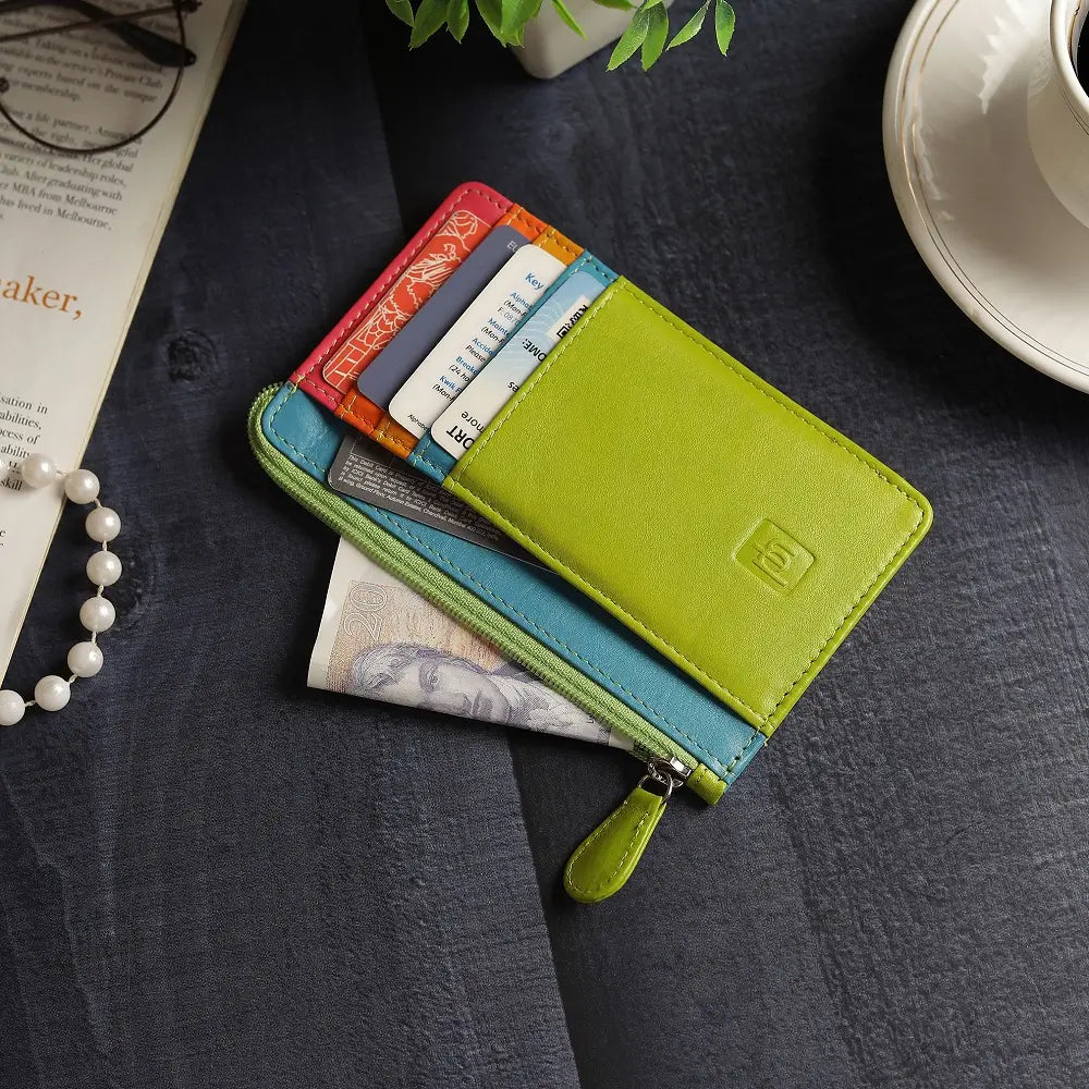 Lime Card Holder Purse with multiple card slots on a dark surface with a book and plant in the background.