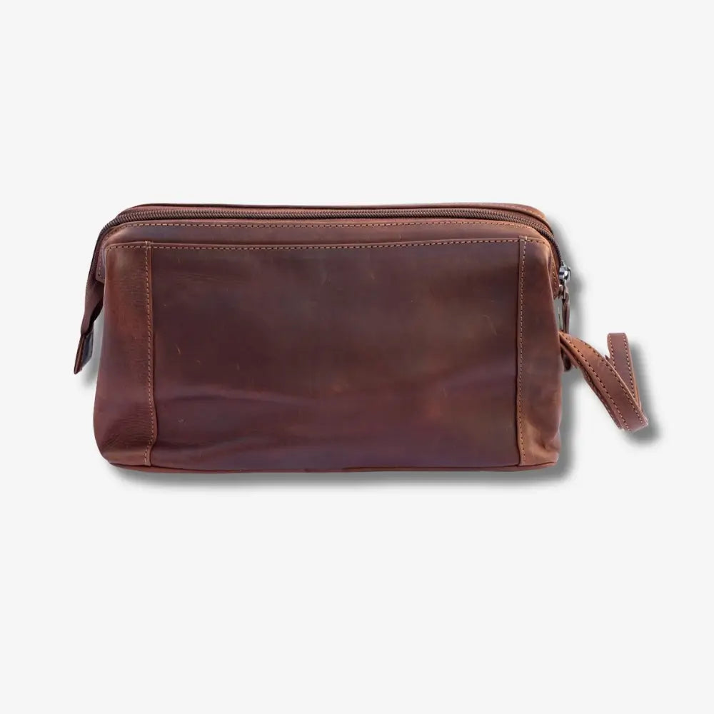 A tan leather zippered pouch with a matching wrist strap, shown against a plain light gray background.