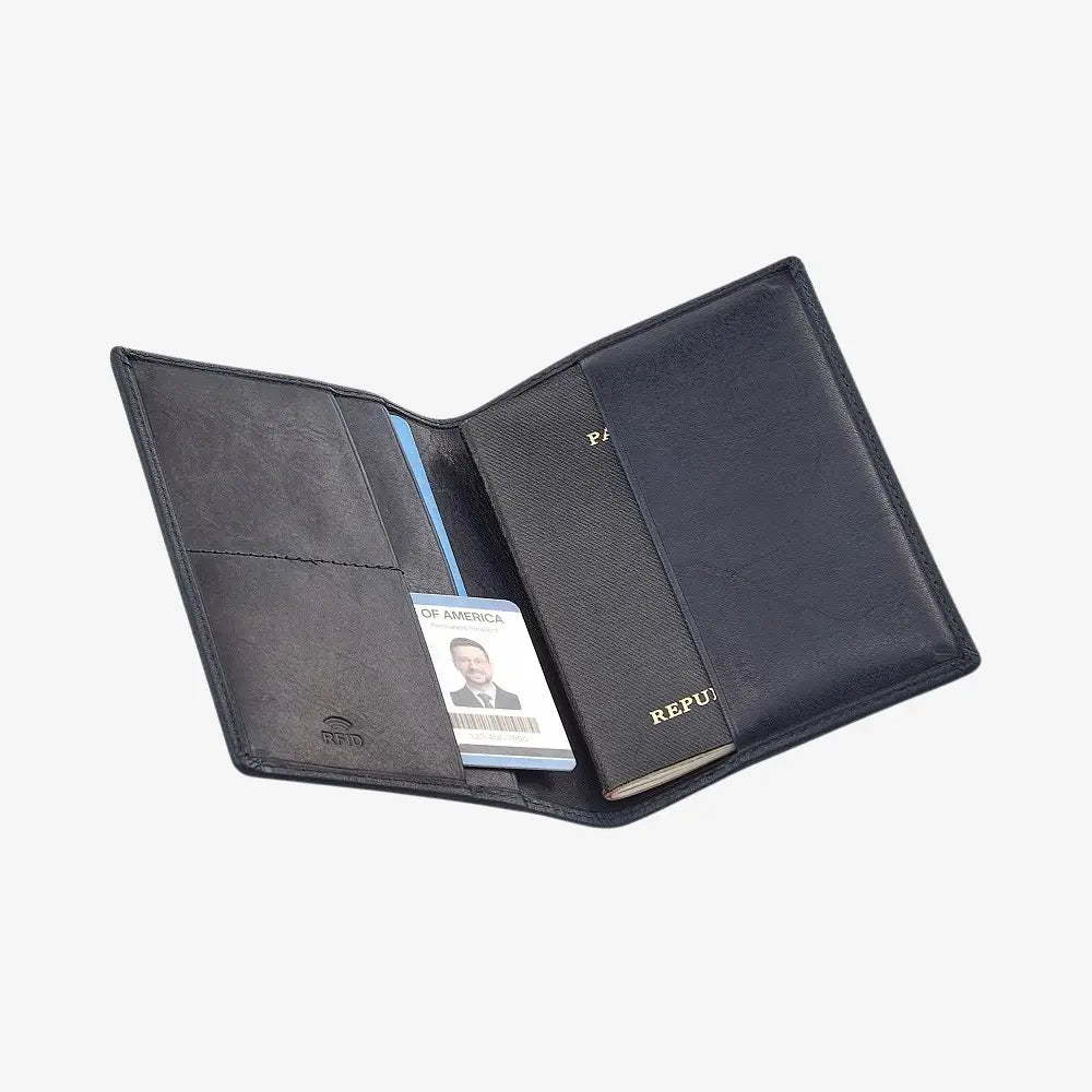 Navy leather passport holder with a visible brand name on a white background