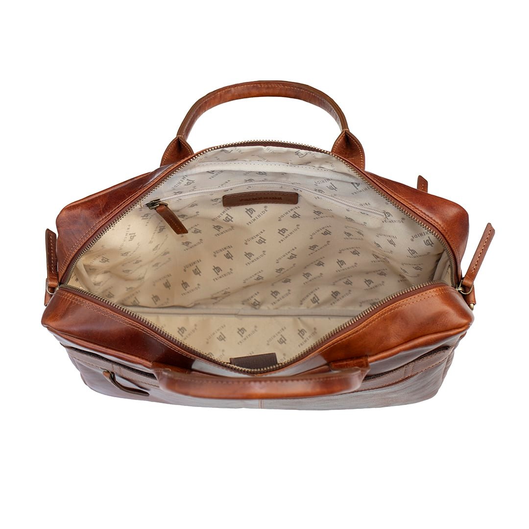 brown leather bag, open to show a lined interior and a zipped pocket