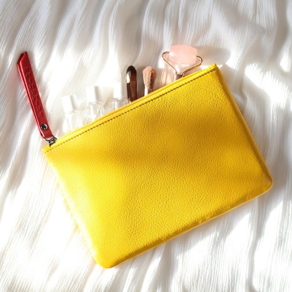 Slim soft yellow leather makeup pouch – side profile