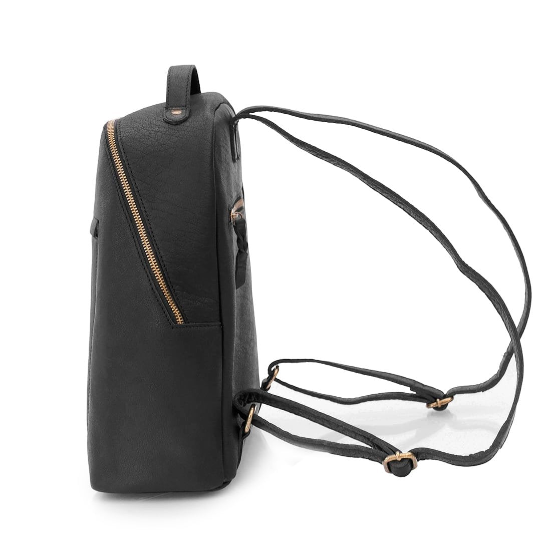 black leather backpack, side view to show angled zipper and leather shoulder straps. there is A zipper to the back of the backpack.