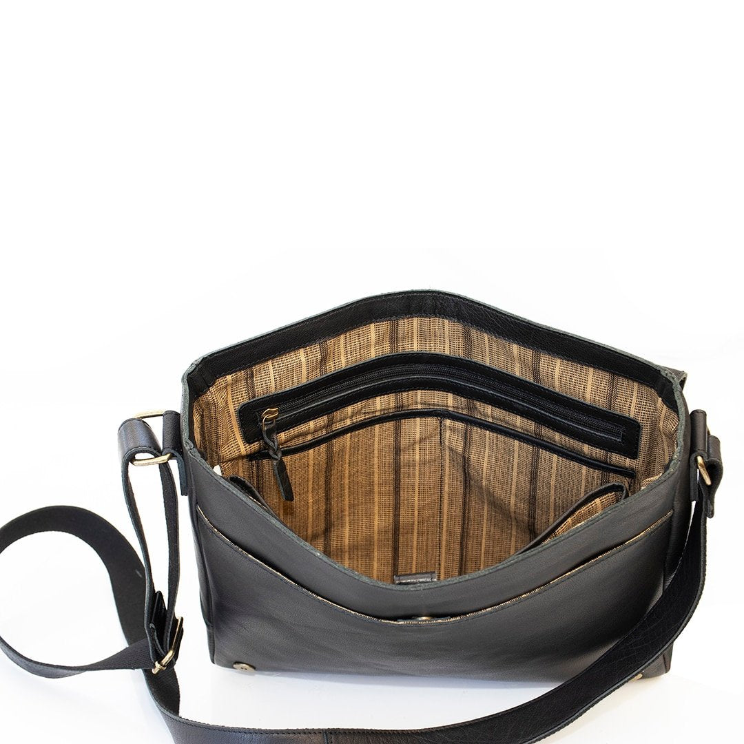 the interior of a messenger bag, fabric lined with a zipped pocket