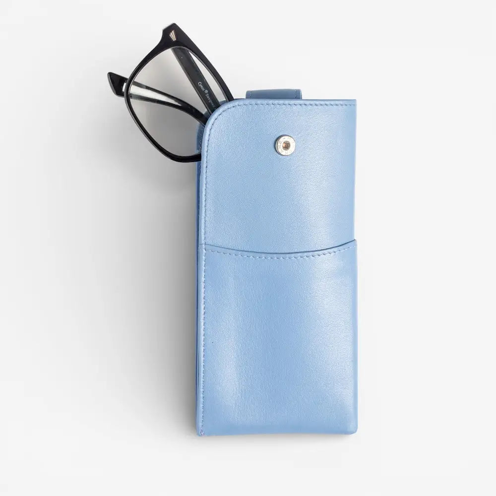 Pastel blue glasses pouch with a small round metallic button on a white background