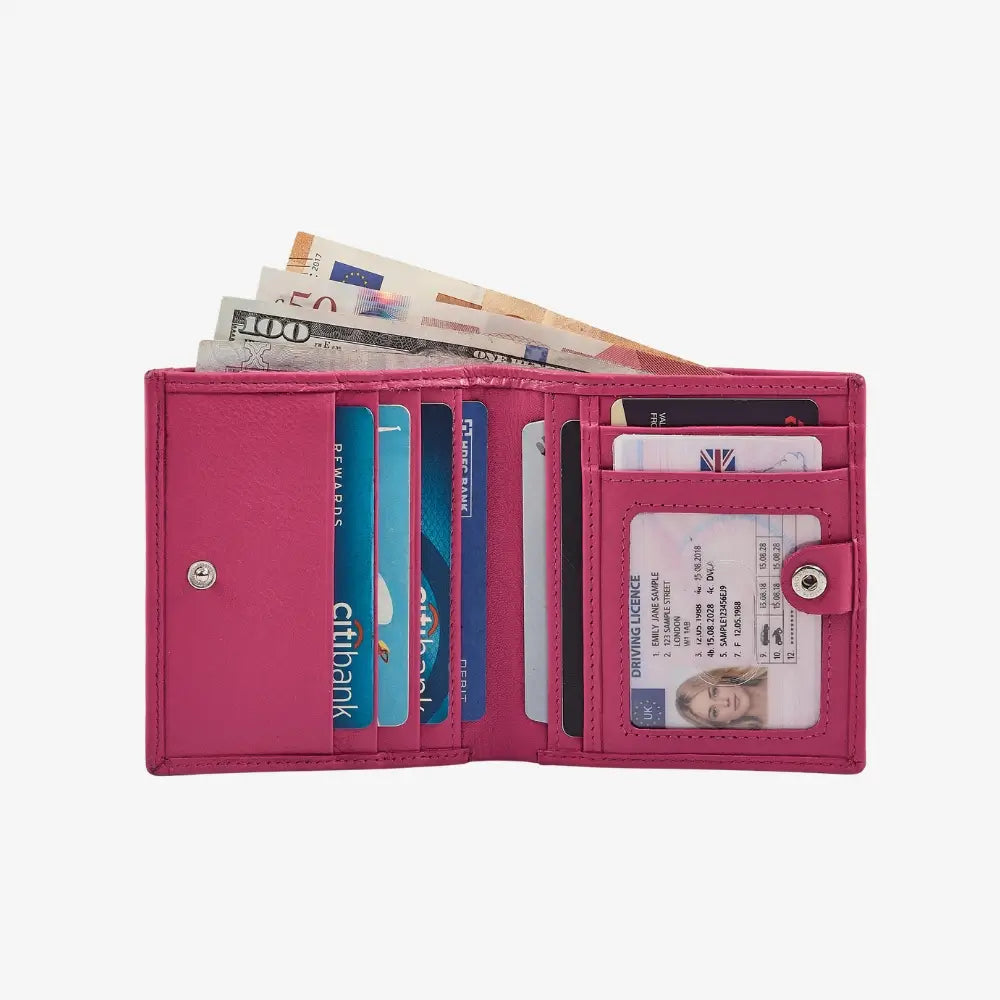 Pink wallet with various cards and money on a white background