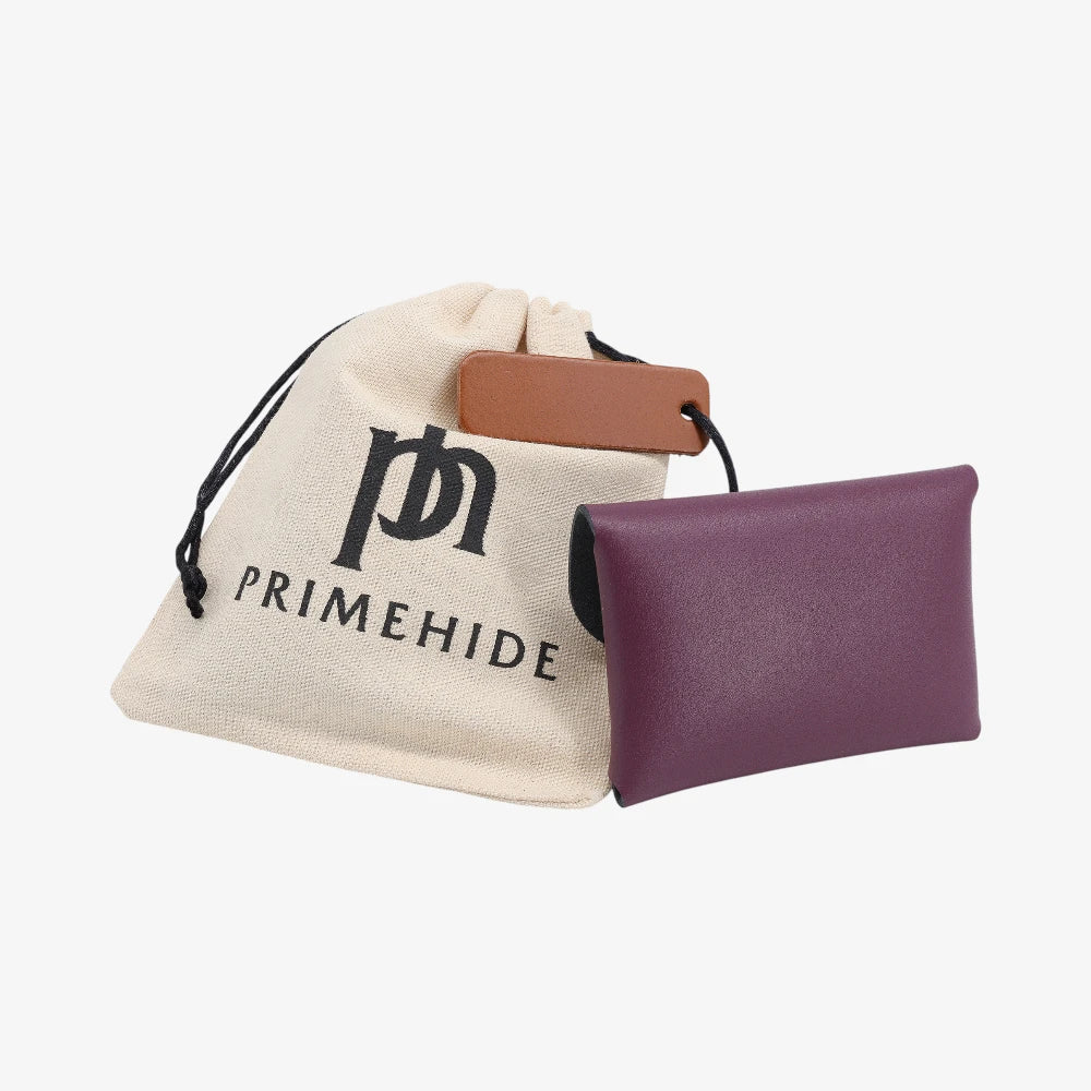 Back view of plum leather coin purse with textured finish and branded pouch