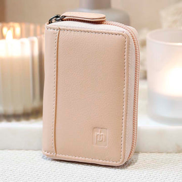 Soft leather card holder wallet with zip closure in a peach colour 