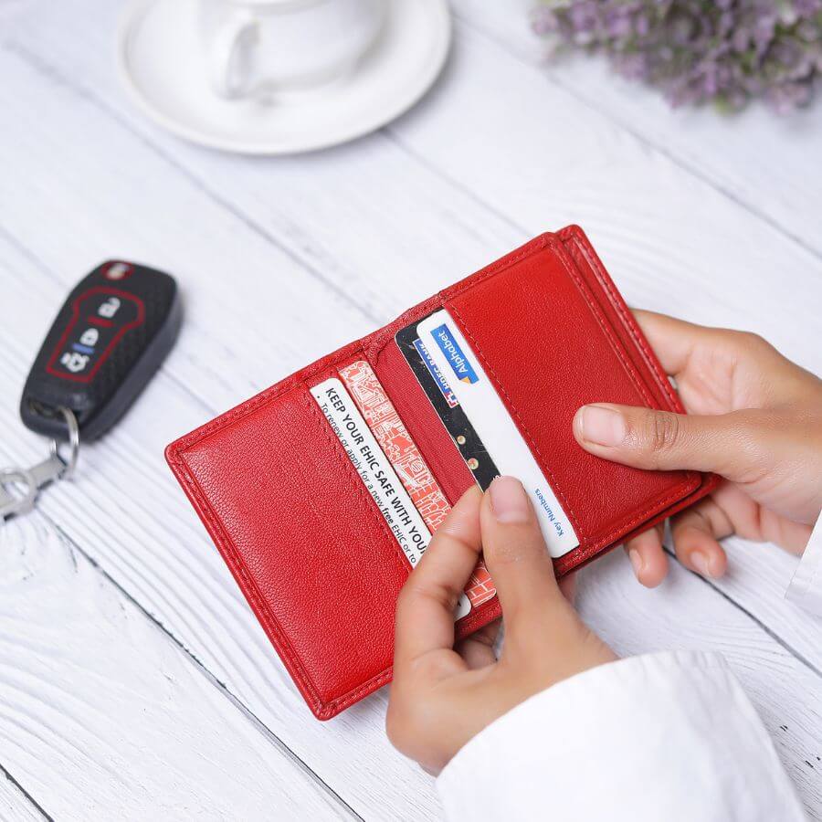 Red leather wallet with a brand logo on a white background
