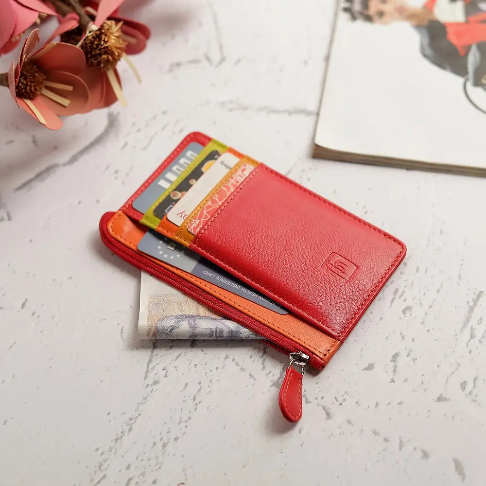 Front view of Red Card Holder Purse  with cards on a textured surface