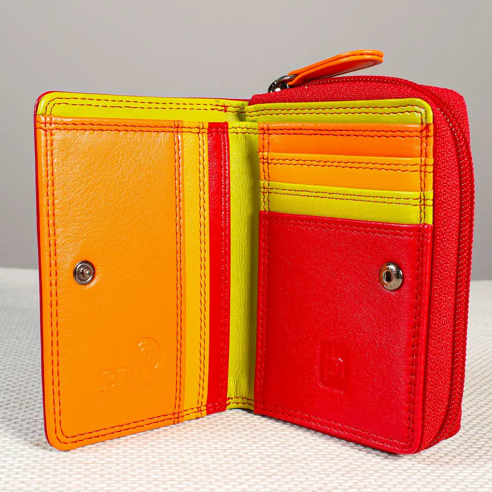 A small leather wallet shown open, featuring a bold color-blocked design in red, orange, and bright yellow-green. The interior includes card slots, a zippered compartment, and snap-button closures.