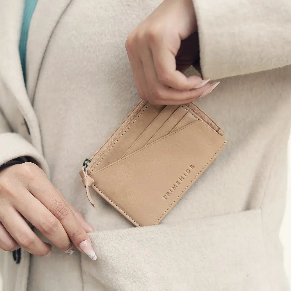 Person holding a Sand leather wallet with 'PRIMEHIDE' branding.