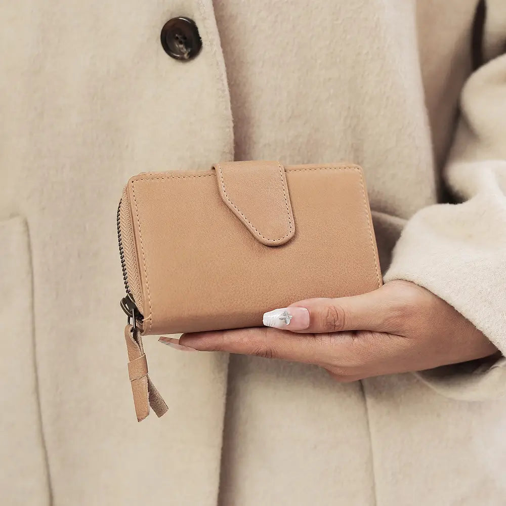 Sand Renata bifold purse in washed Cancun leather held in hand