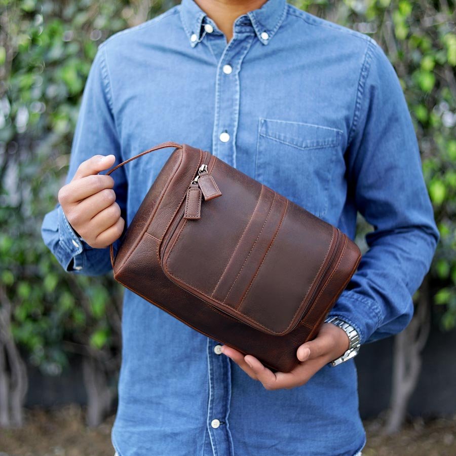 Men’s leather hanging wash bag in bathroom, perfect grooming gift for husbands, dads or frequent travellers.
