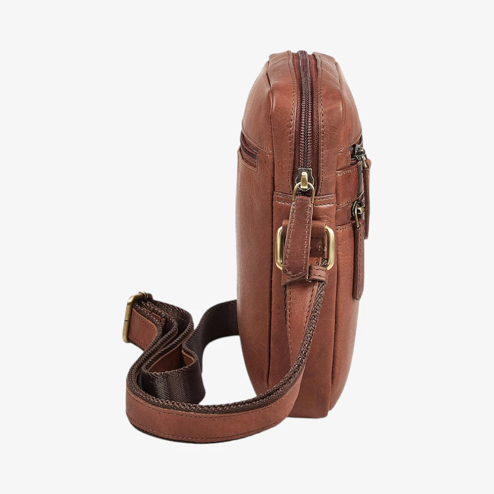 Brown leather crossbody bag with gold zipper on a white background