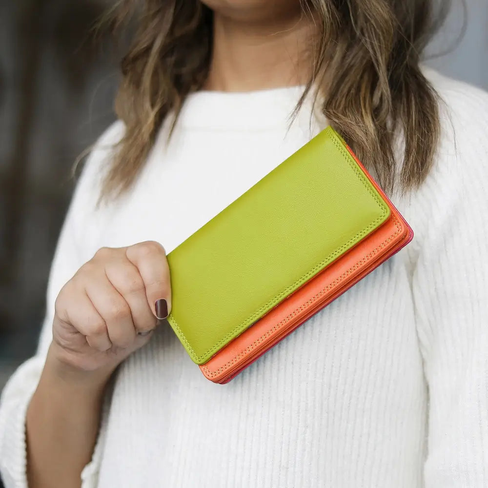 Person holding a two-tone leather wallet with a green top and orange bottom.