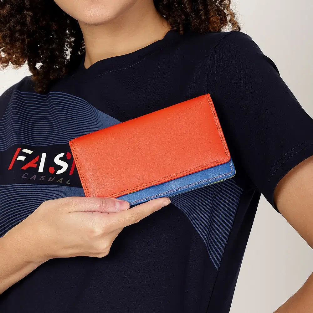 Person holding a orange wallet against a black background