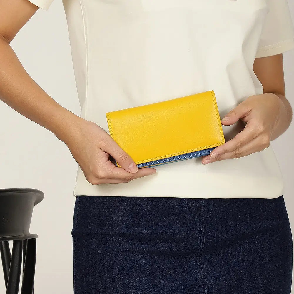 Person holding a yellow wallet against a plain background