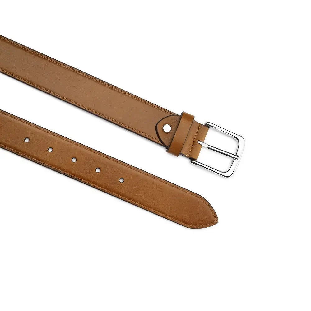 Top angle view of Tan leather belt with a silver buckle on a white background