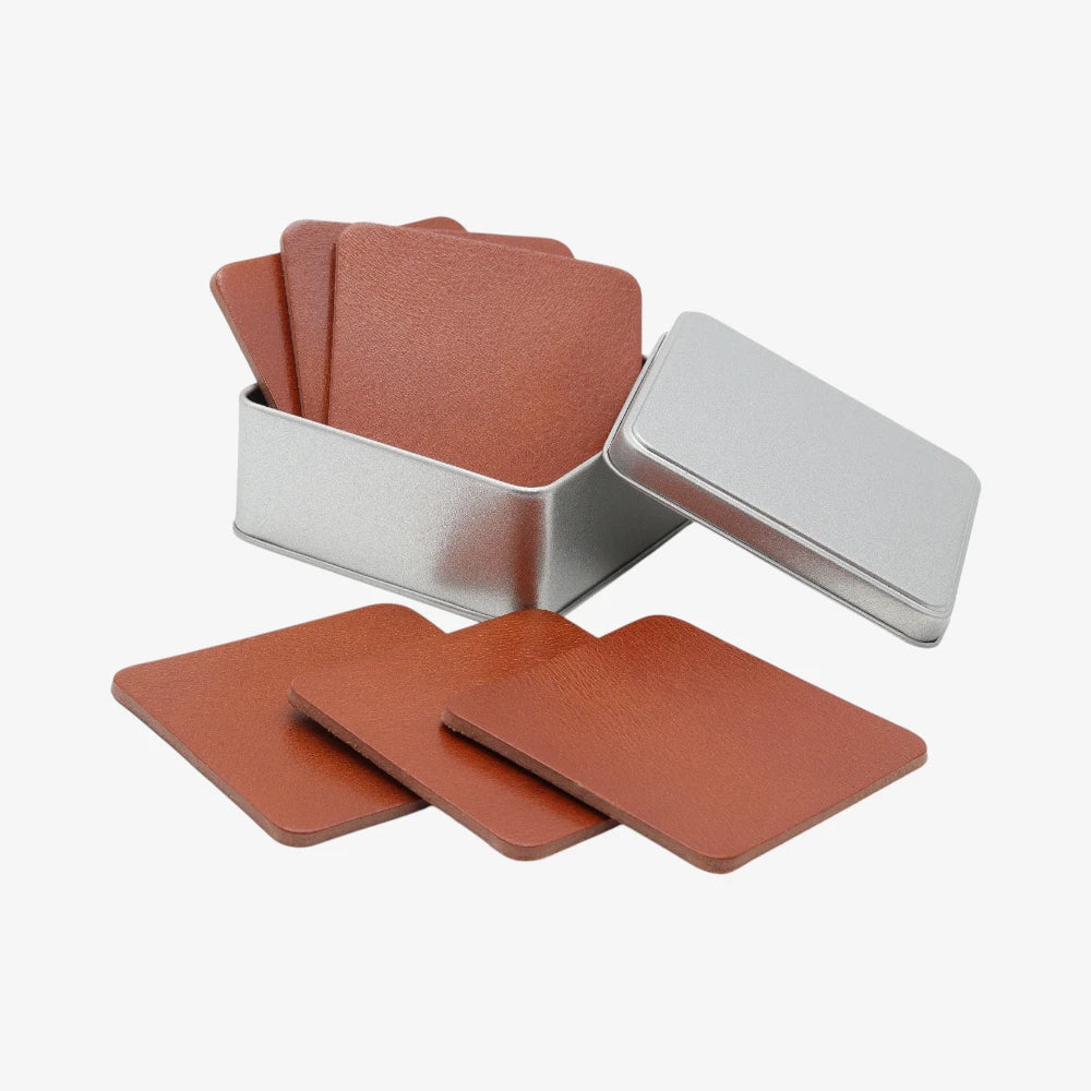 Set of tan coasters with a silver holder on a white background