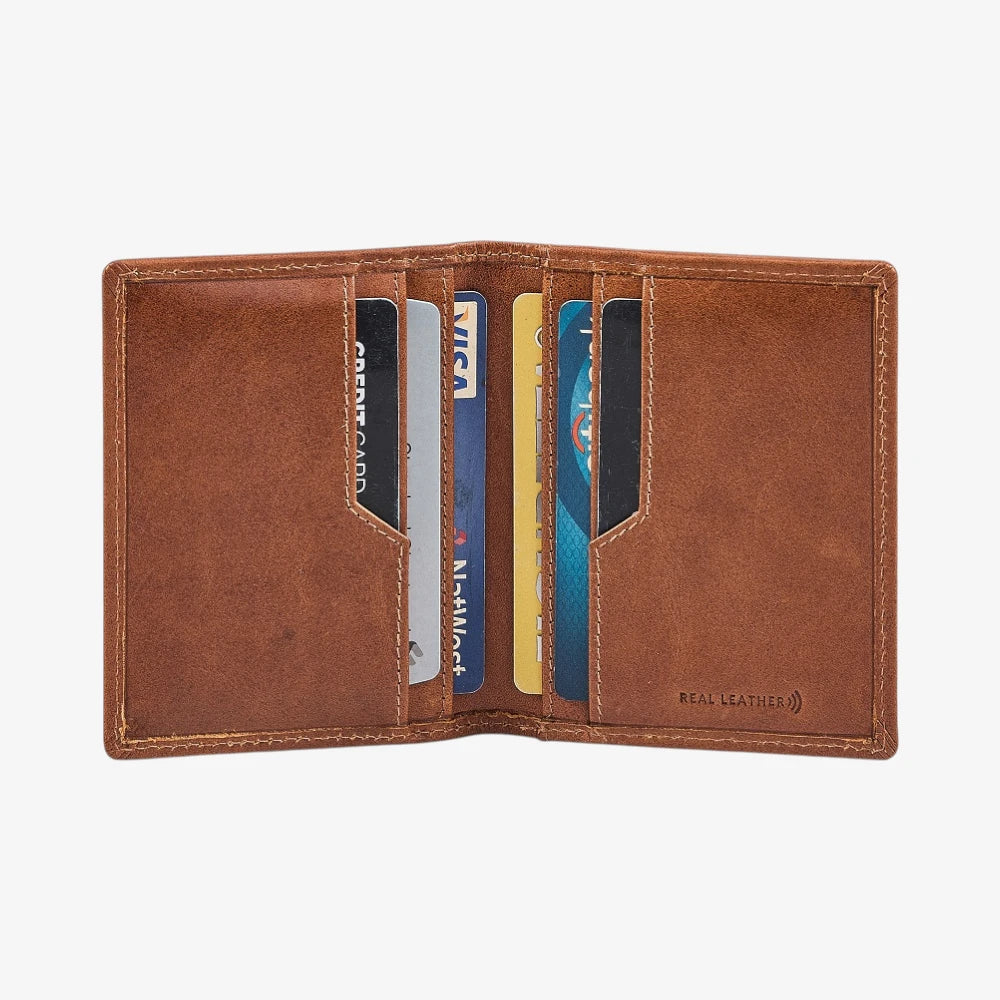 Tan leather credit card holder with cards on a white background