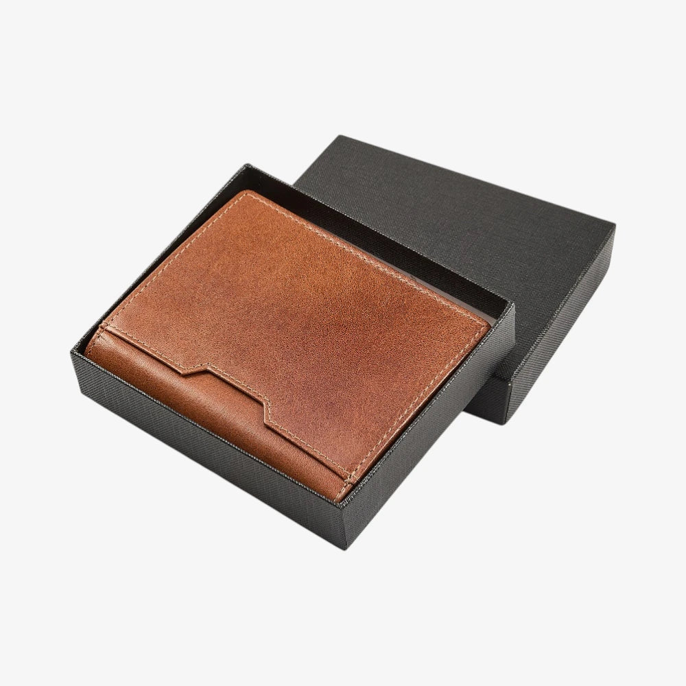 Tan leather wallet in a black box on a white background