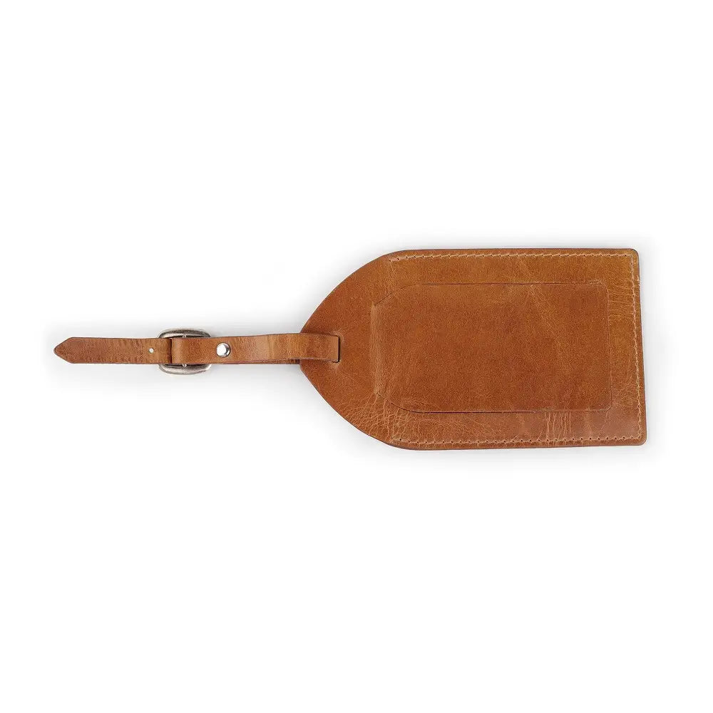 Side  view of tan full-grain leather luggage tag showing ID window, flap cover, and buckle strap.