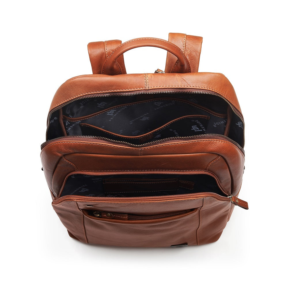 Tan leather backpack on a white background