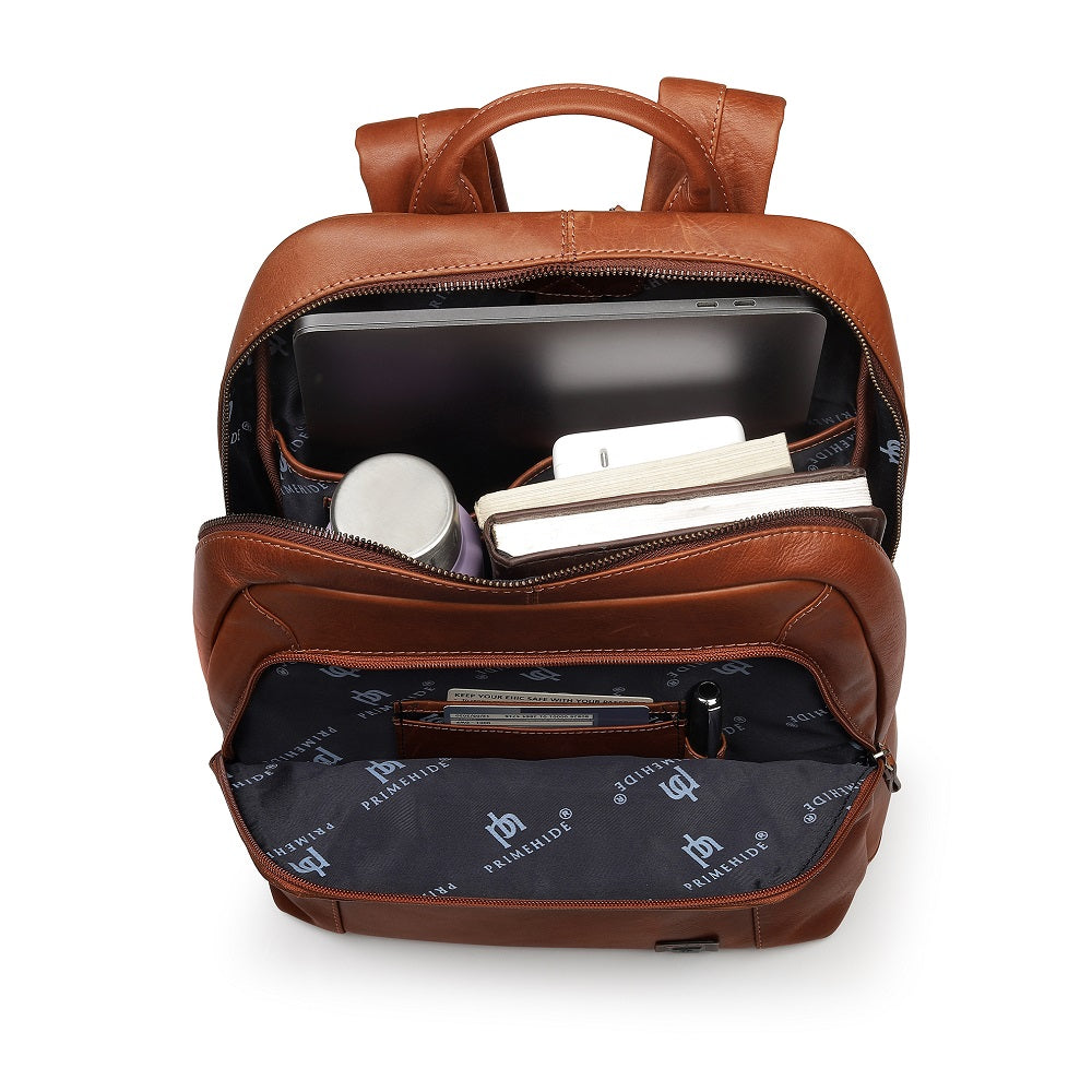 Tan leather backpack with items inside on a white background