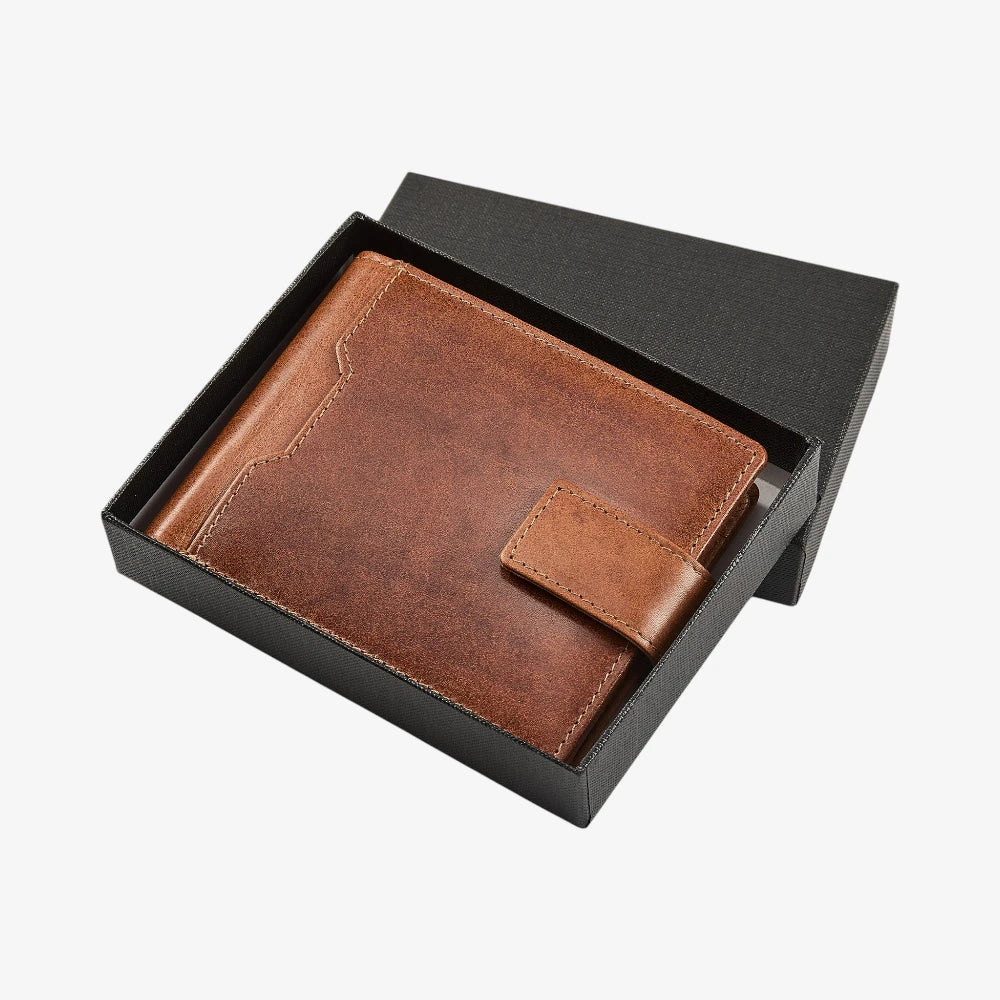 Tan leather wallet in a black box on a white background