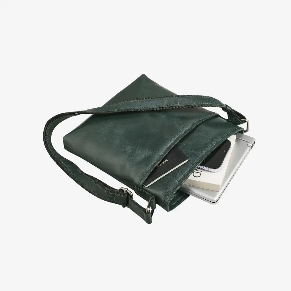 Teal leather crossbody bag with a phone and wallet inside on a white background