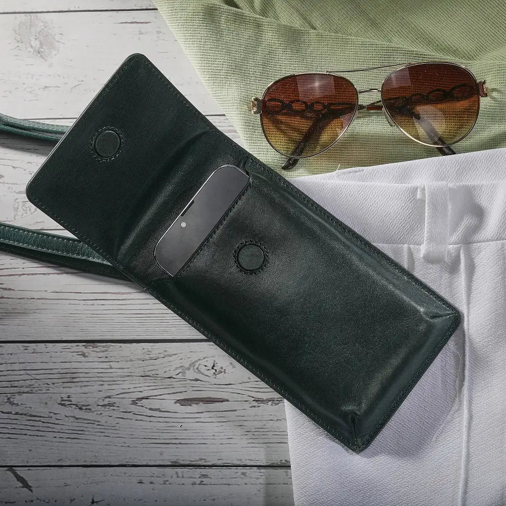 Black leather wallet with sunglasses on a wooden surface