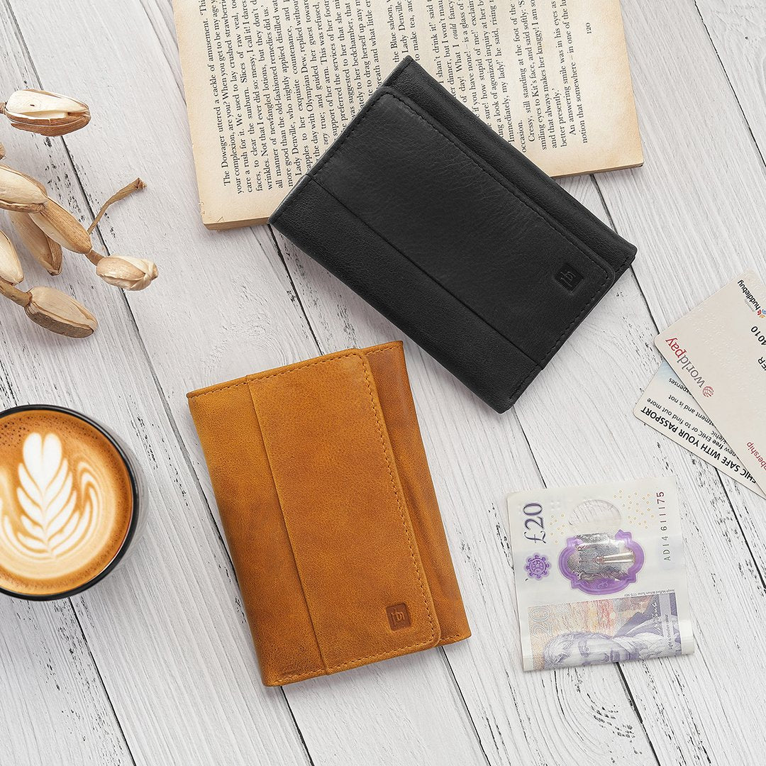 A person holding the black trifold wallet, demonstrating its compact size and easy portability, perfect for everyday use.