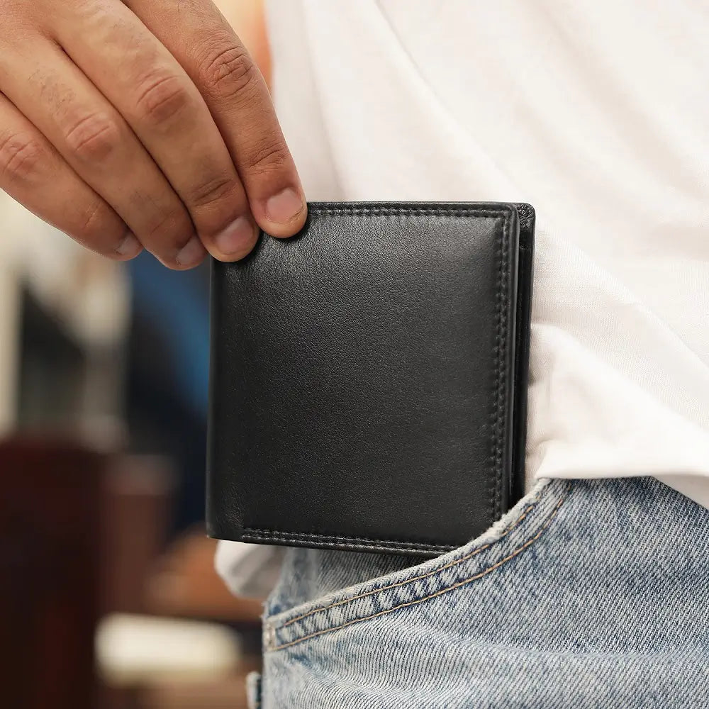 Black Leather wallet with RFID protection held in hand showing compact size