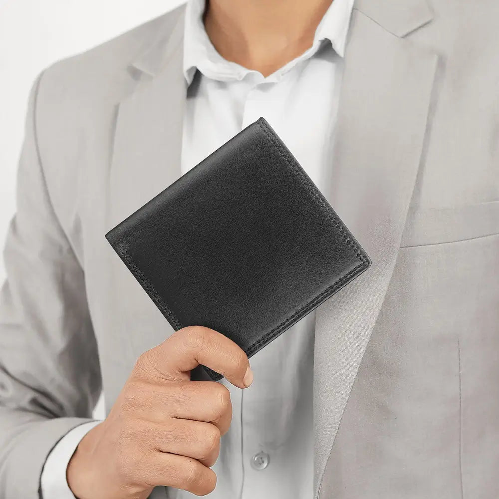 Black Leather wallet with RFID protection held in hand showing compact size