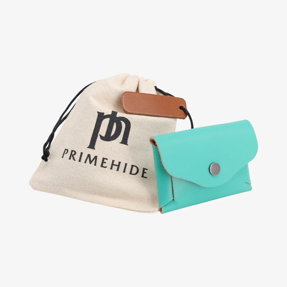 Turquoise leather coin purse with flap closed displayed beside Primehide dust bag