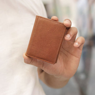 person holding tan tuscan mens credit card holder