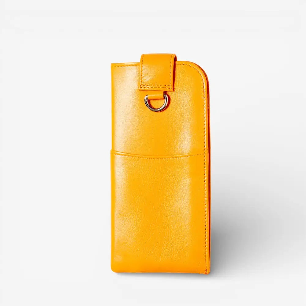 Yellow leather glasses pouch with a metallic ring on a white background