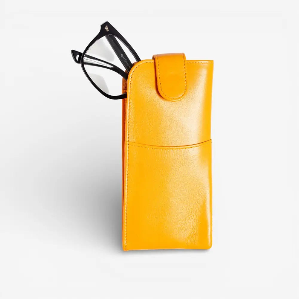 Yellow glasses case with a pair of glasses on a light gray background