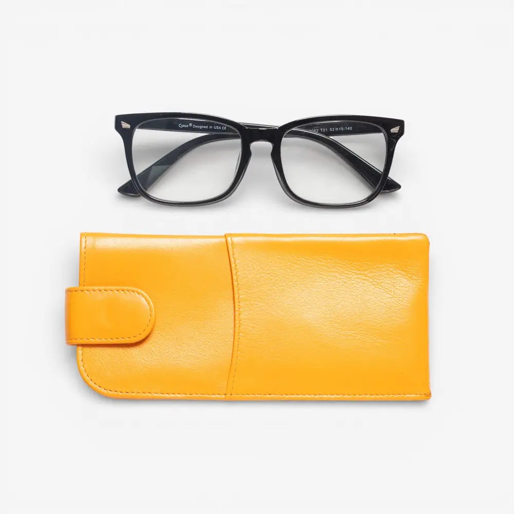 Black glasses on a yellow case against a white background