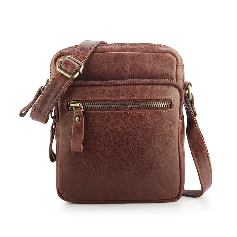 Brown leather crossbody bag with gold zippers on a white background