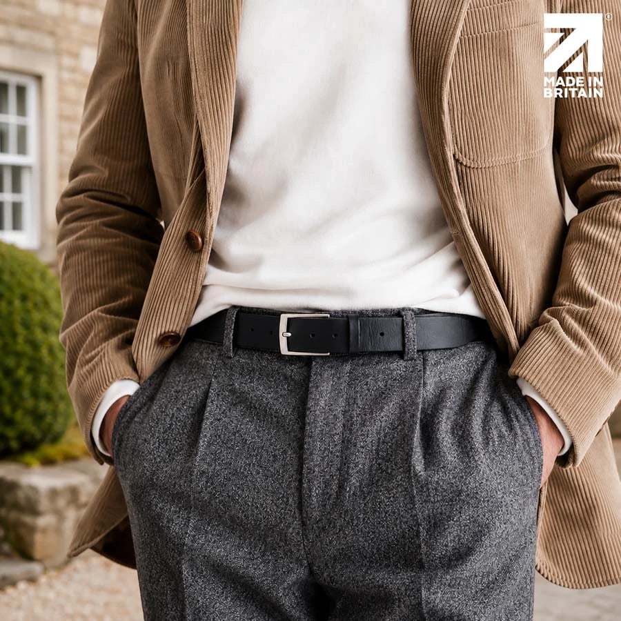 Men’s black 35mm full-grain Italian leather belt worn with tailored grey trousers